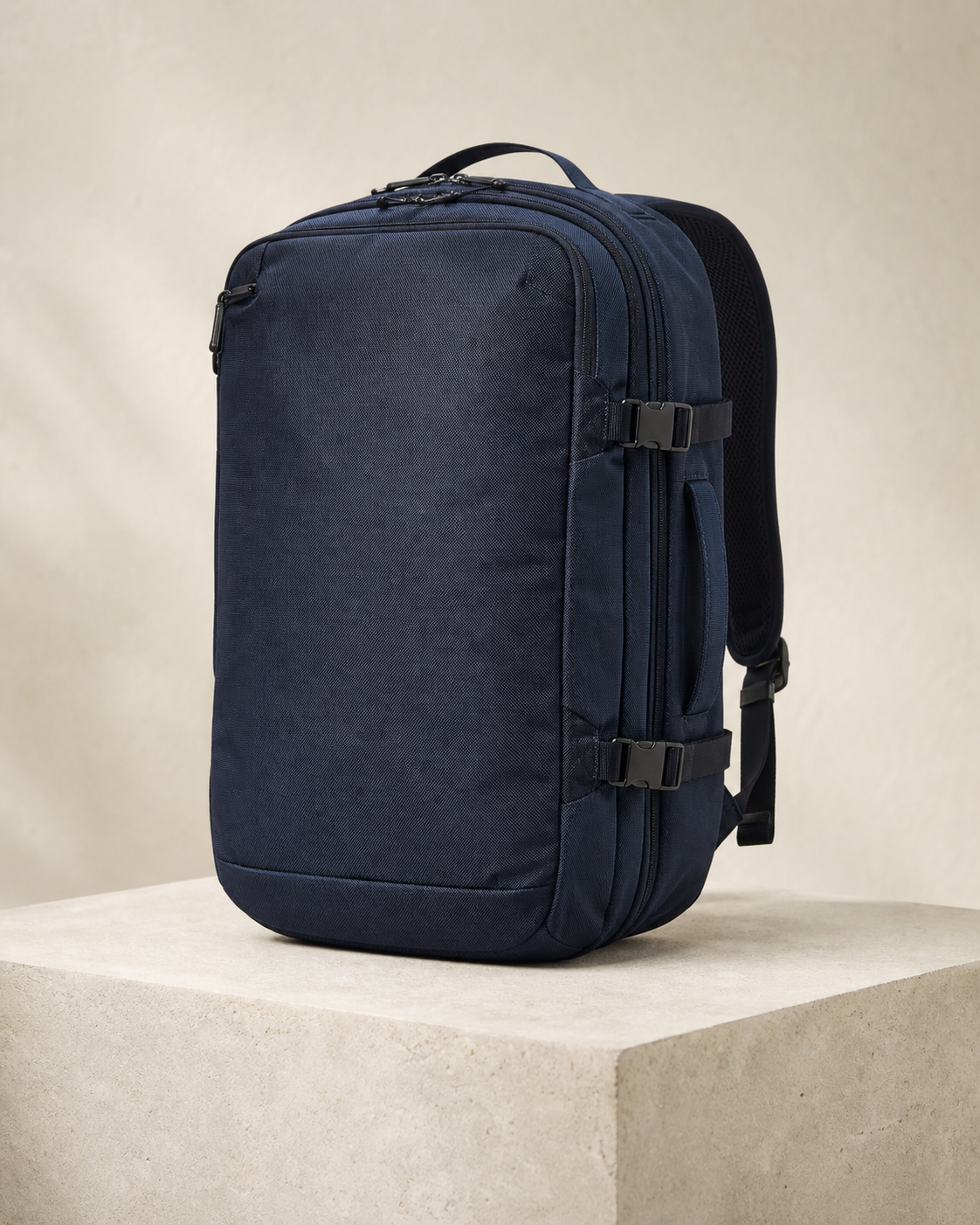Tomei Cabin 35 in Deep Navy, a 35 litre everything you own, above your seat bag, photographed on a stone plinth