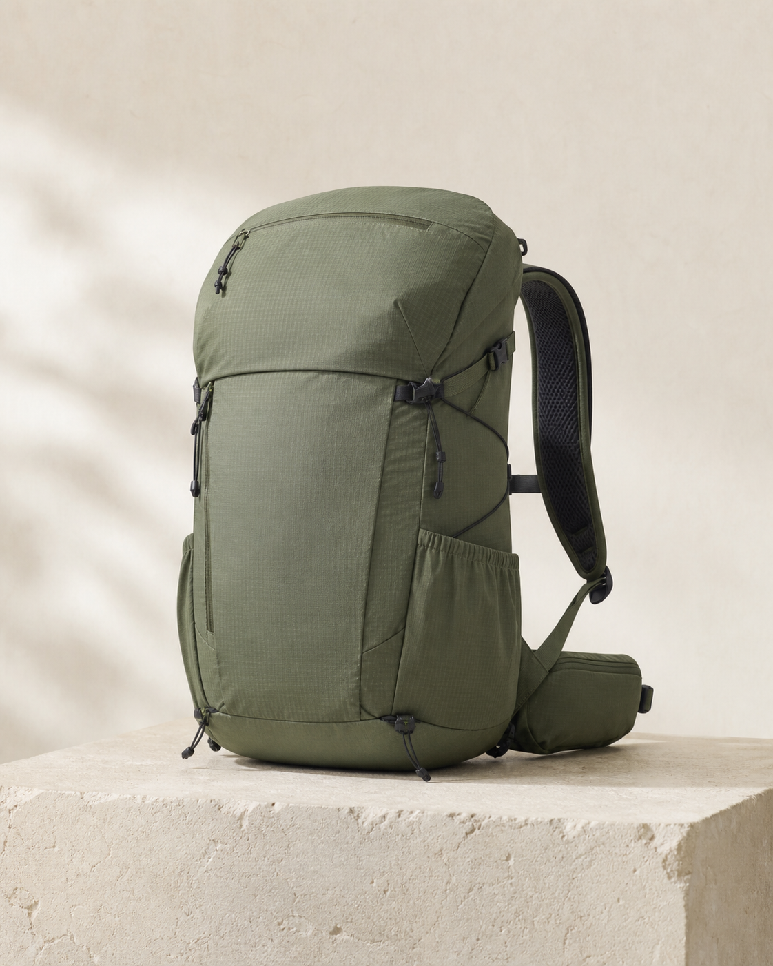 Tomei Trail 22 in Moss, a 22 litre a wet day, handled quietly bag, photographed on a stone plinth