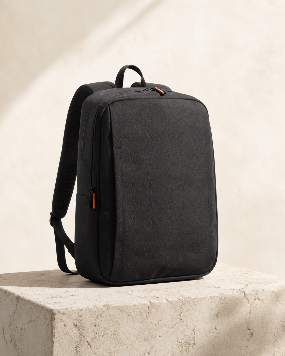 Tomei Metro 16 in Ink Black, a 16 litre the short, repeated journey bag, photographed on a stone plinth